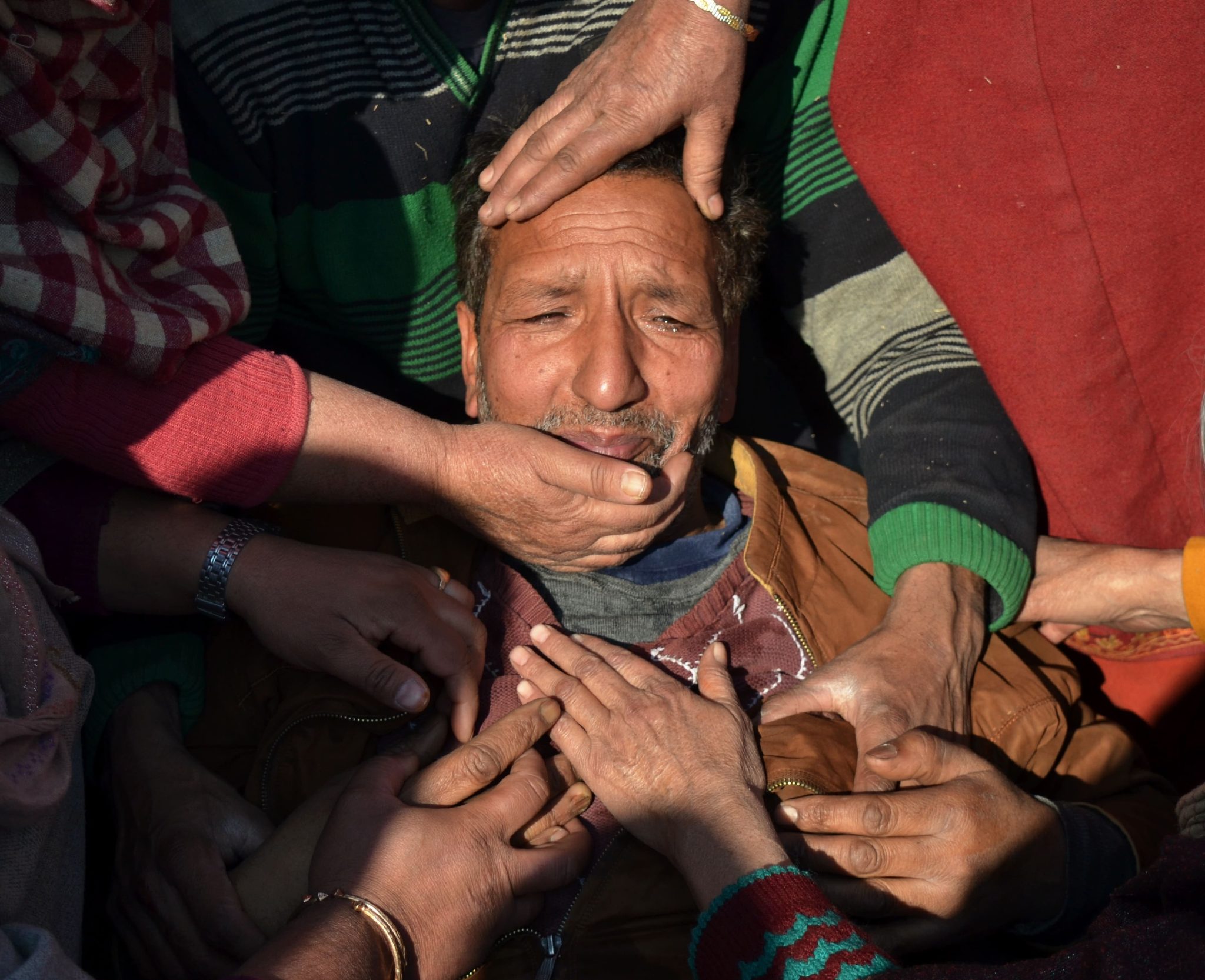 Dec. 15, 2018, Pulwama, Kashmir — Mohammad Yusuf Najar is consoled during the funeral procession of his 18-year-old son Owais Yusuf Najar, who was killed by Indian army troops.