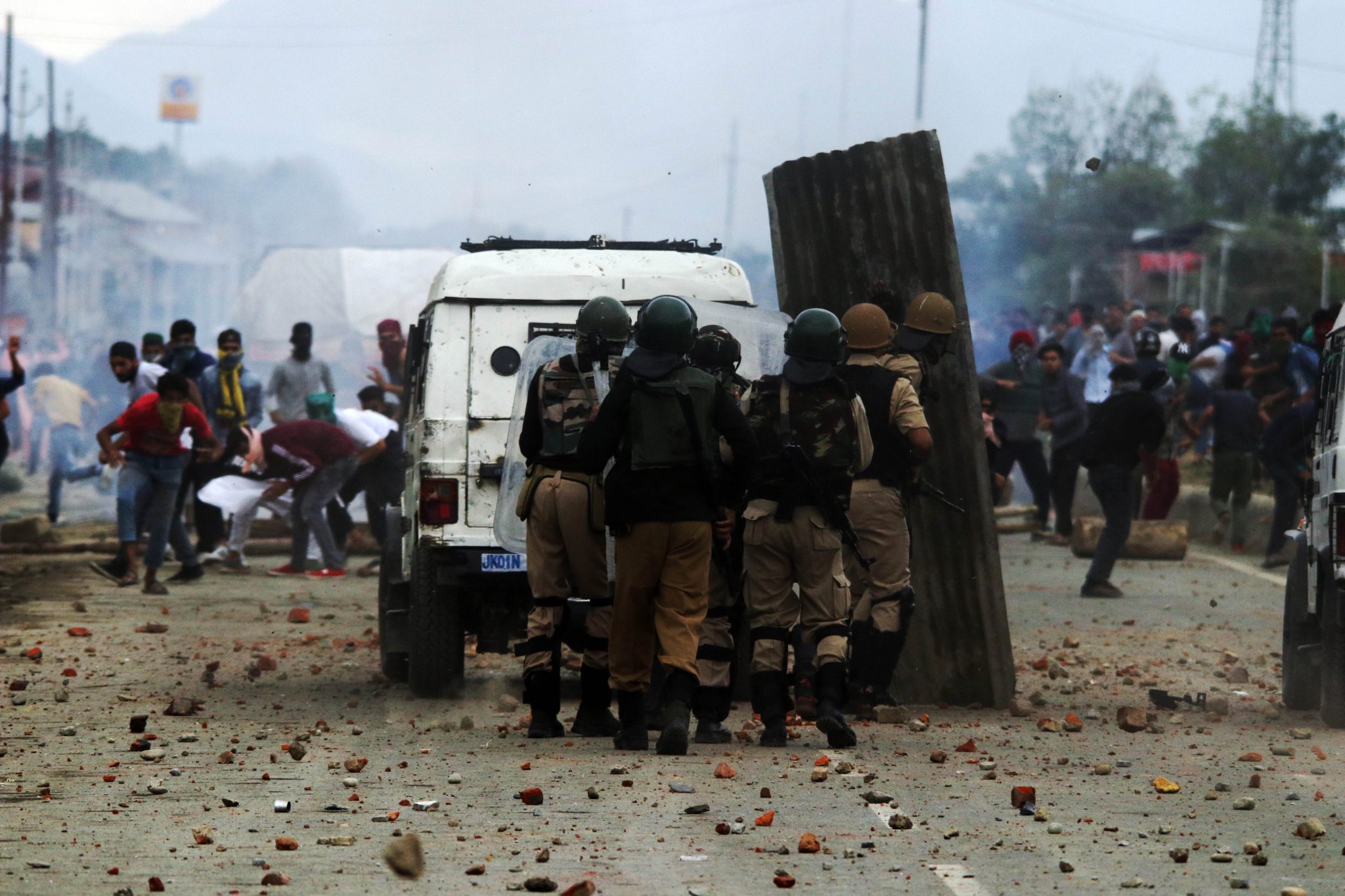 June 22, 2018, HMT, Srinagar, Kashmir — Protesters throw stones and bricks at Indian police during a demonstration following the death of four rebels, a counterinsurgency police official, and a civilian during a gunbattle in disputed Kashmir.