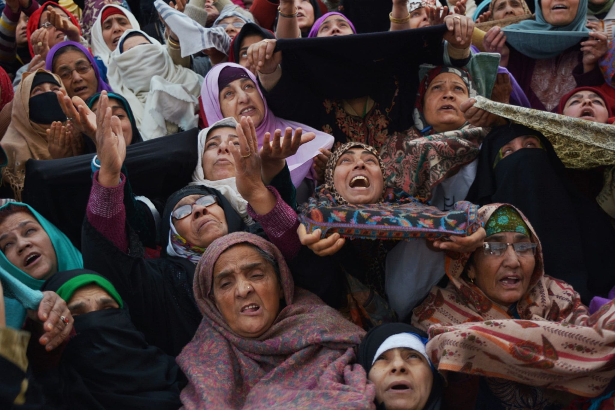 SRINAGAR, KASHMIR, INDIA - APRIL 14: Kashmiri Muslim women pray as a Muslim cleric displays the holy relic believed to be the whisker from the beard of the Prophet Mohammed on the occasion of the Muslim festival Mehraj-u-Alam, which marks ascension day, the journey from earth to heavens of the Prophet Mohammed, at the Hazratbal Shrine.
